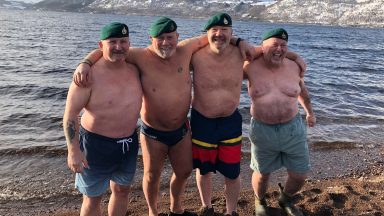 Ex-Royal Marine Tim Crossin takes Loch Ness plunge in the Highlands as part of cancer charity mission