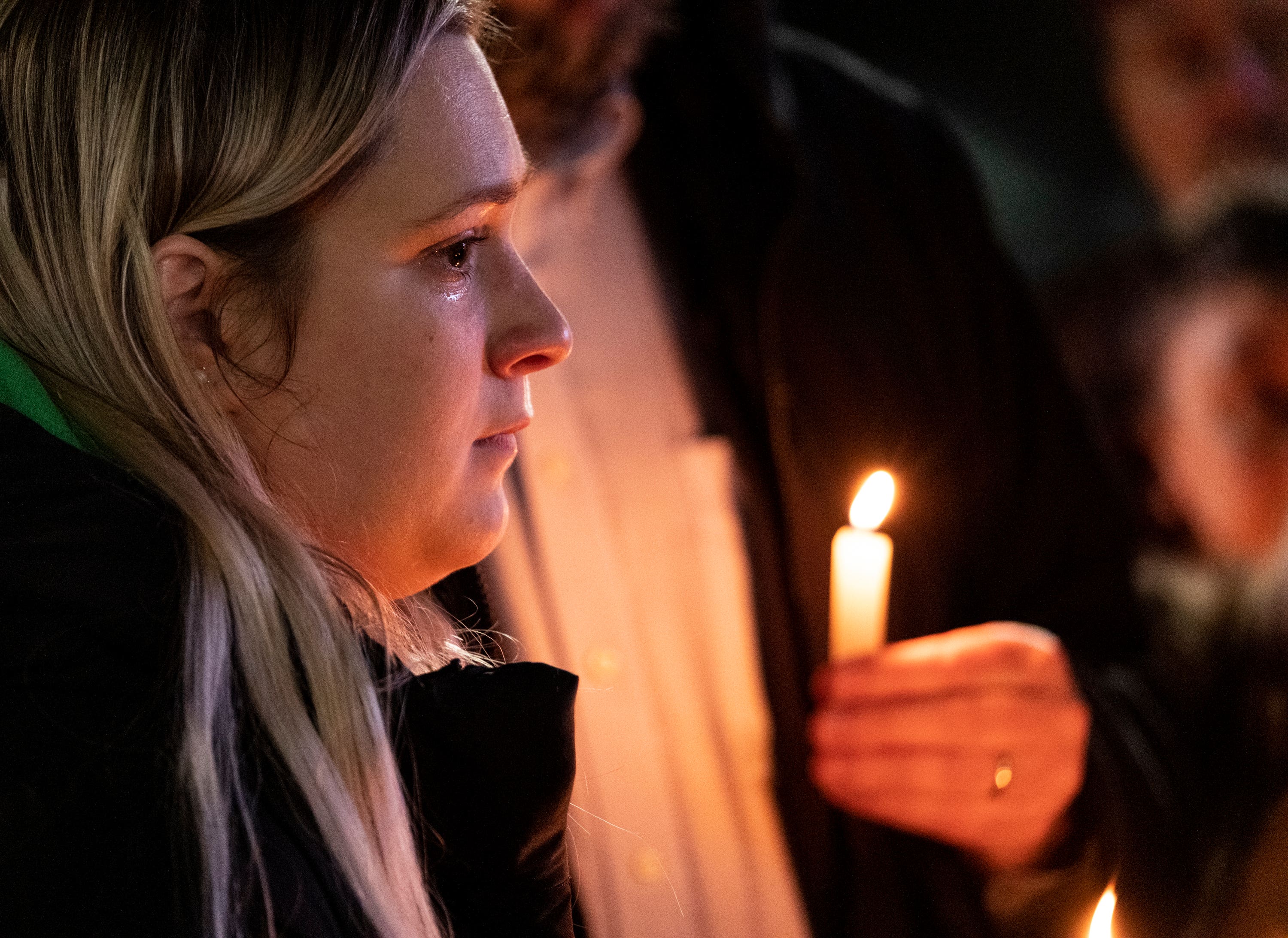 Rosalie List, a coworker at Richneck Elementary, wipes a tear from her eye while speaking during a vigil for Abby Zwerner.