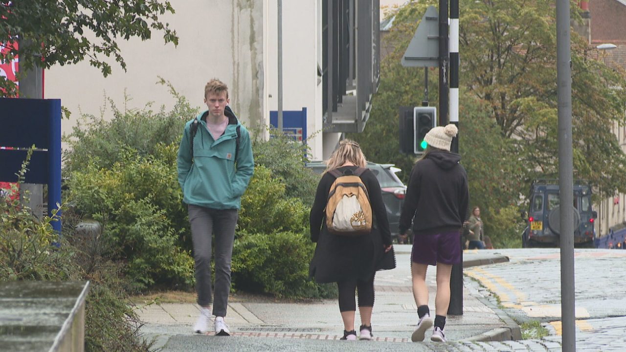 Students are seen walking down the street