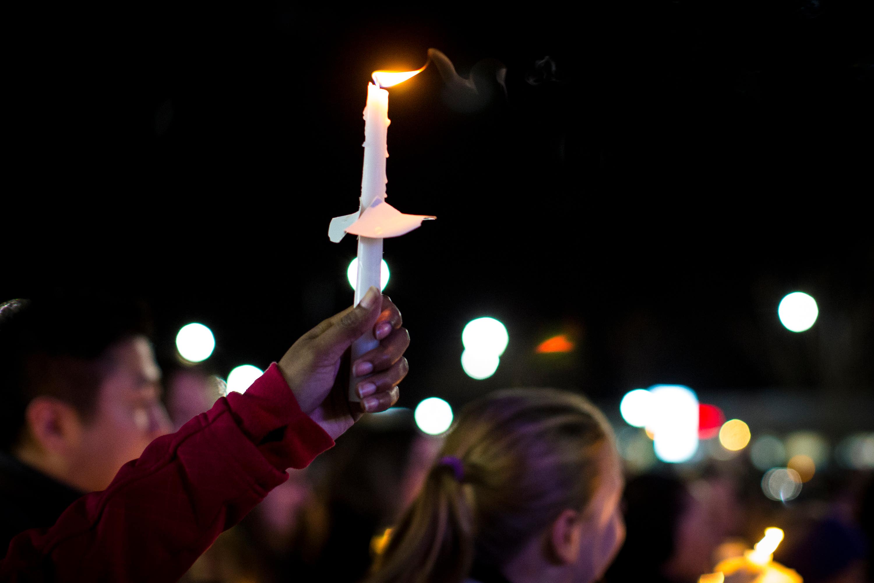 A candle is lifted into the air during the vigil.