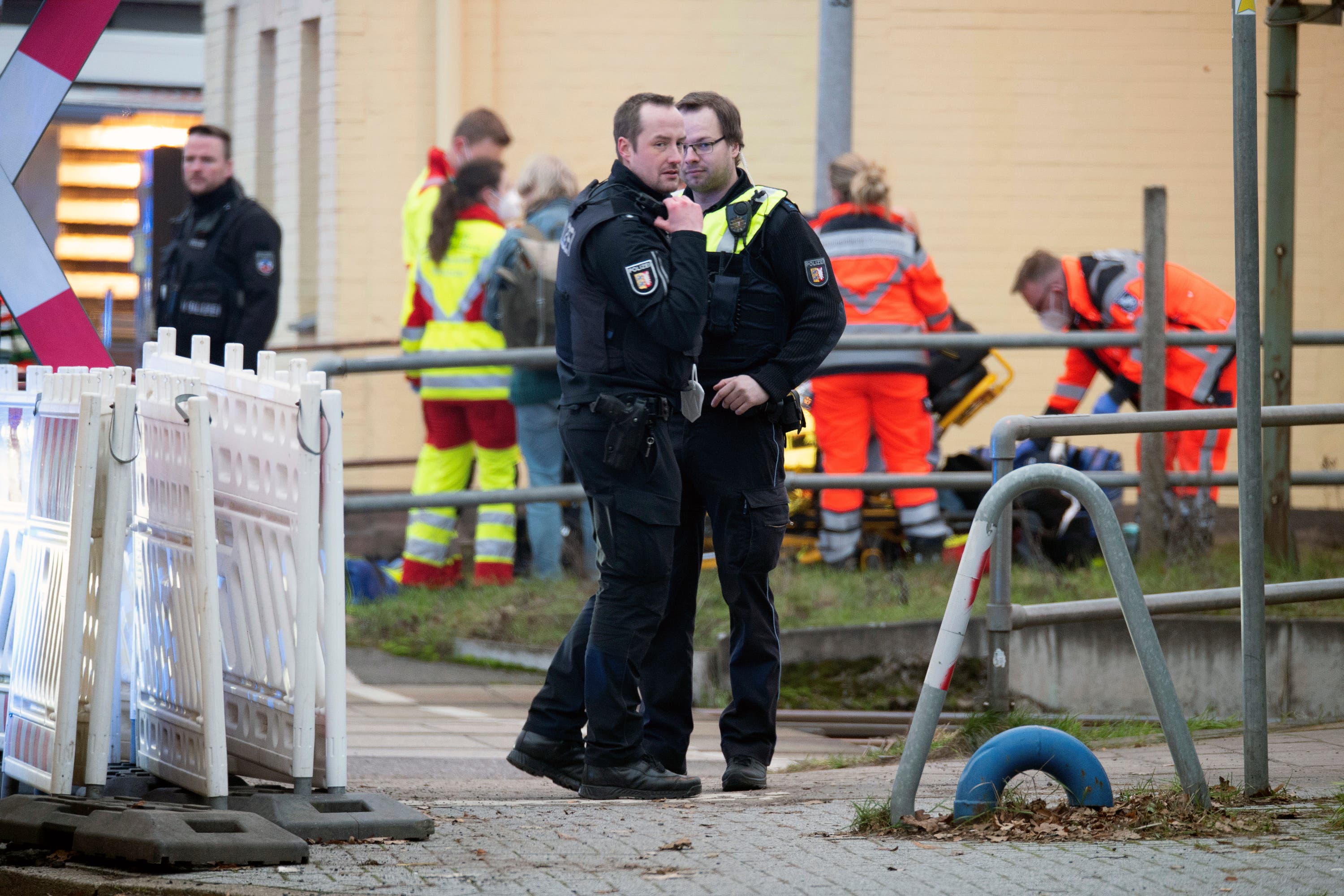 Police officers stand guard as emergency services work at Brokstedt station in Germany 