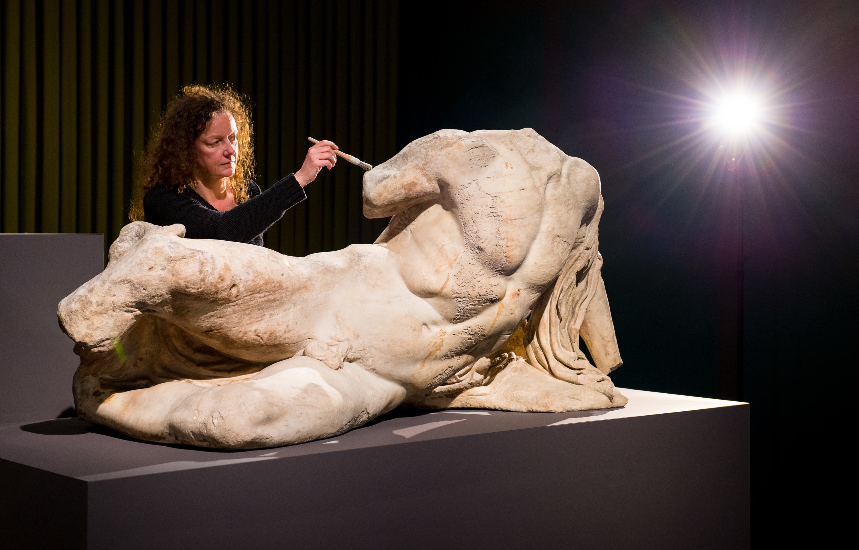 Senior conservator Karen Birkhoelzer with the sculpture The River God Ilissos by Phidias, part of the so-called Elgin Marbles.