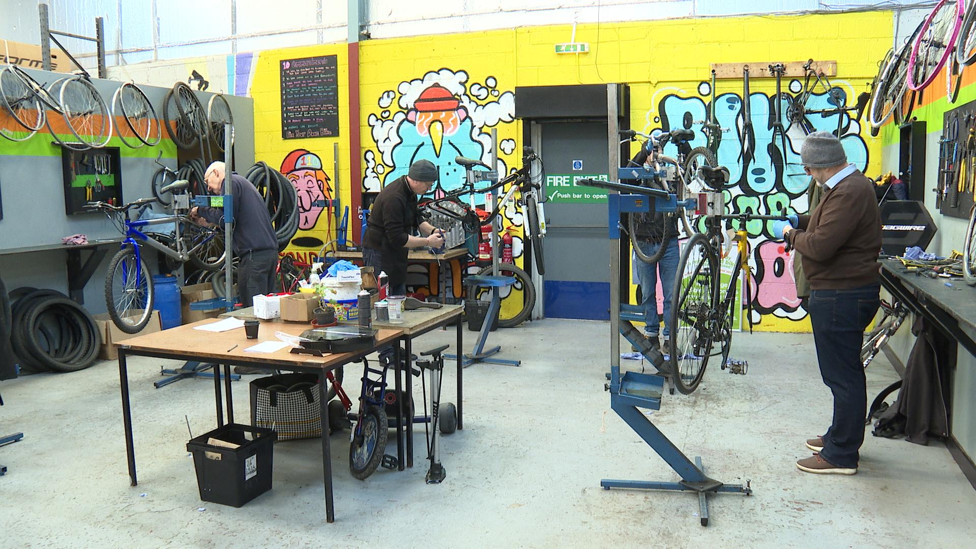 Volunteers restoring bikes.