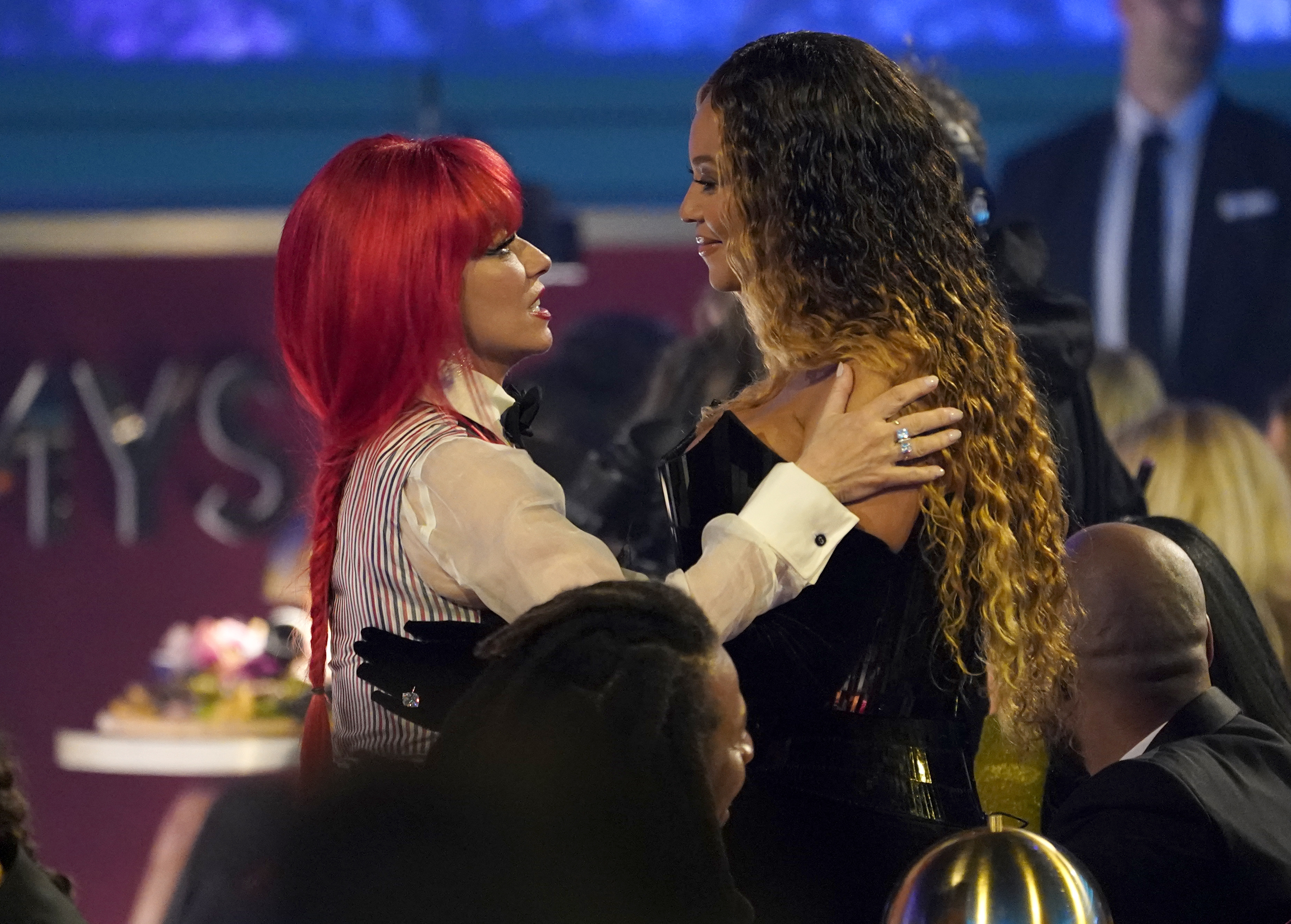 Host Shania Twain embraces Beyonce in the audience at the 65th Annual Grammy Awards.