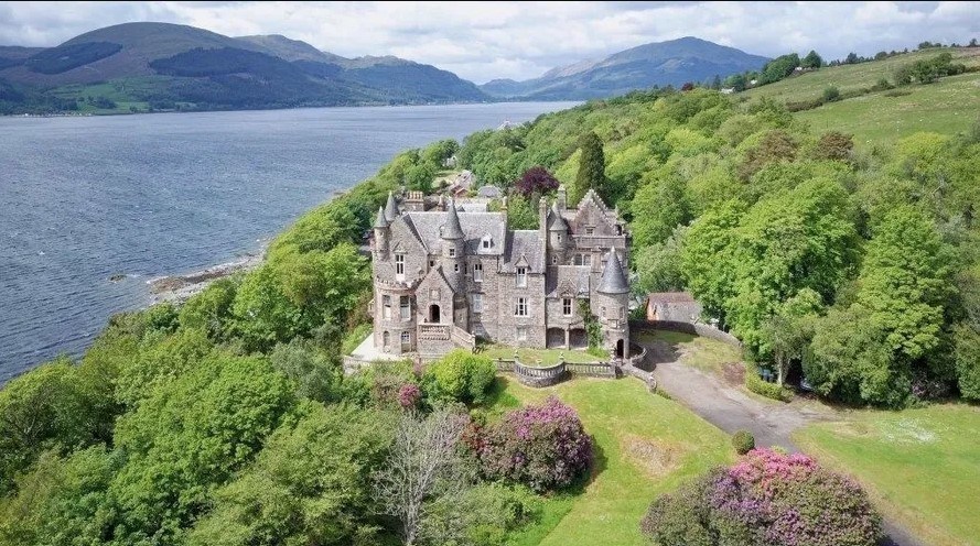 The castle features gardens, a terraced area, and views over Loch Long and the surrounding area.