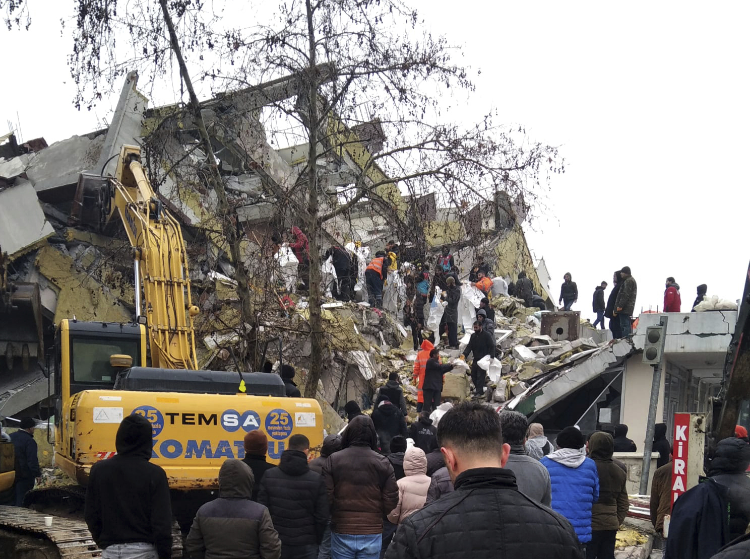 Rescue workers try to reach trapped residents in a collapsed building in Kahta,Turkey.