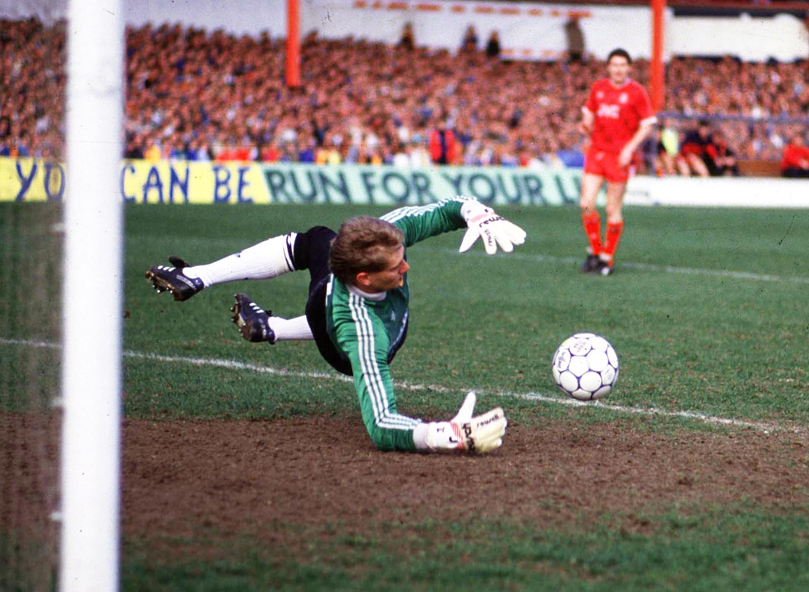 Thomson saves from Aberdeen striker Charlie Nicholas (not in picture).