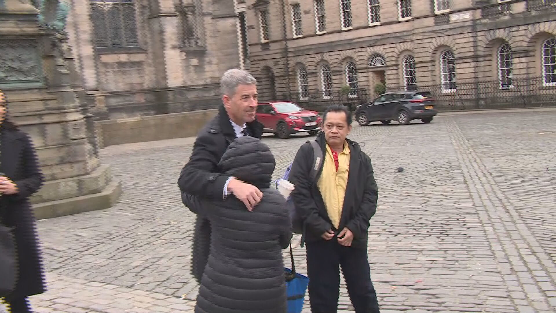 DCI Smith embracing Bennylyn's sister, Shela Aquino, at the High Court in Edinburgh.