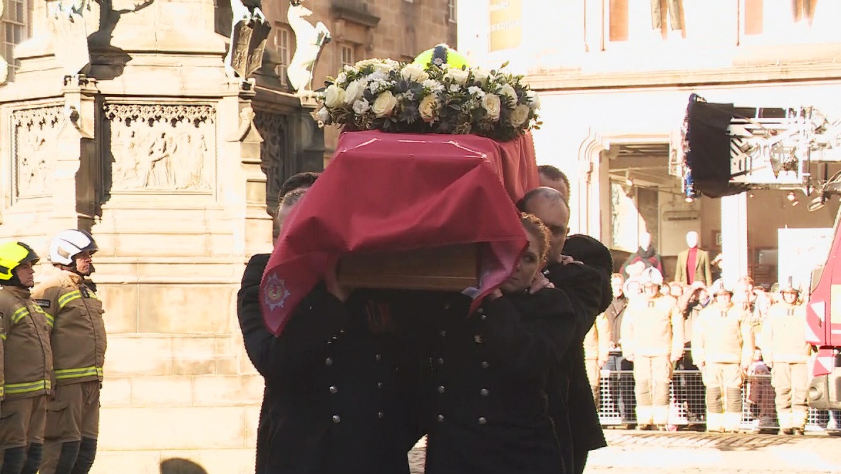 Pallbearers carried the coffin, with Mr Martin's helmet on top, into St Giles Cathedral. 