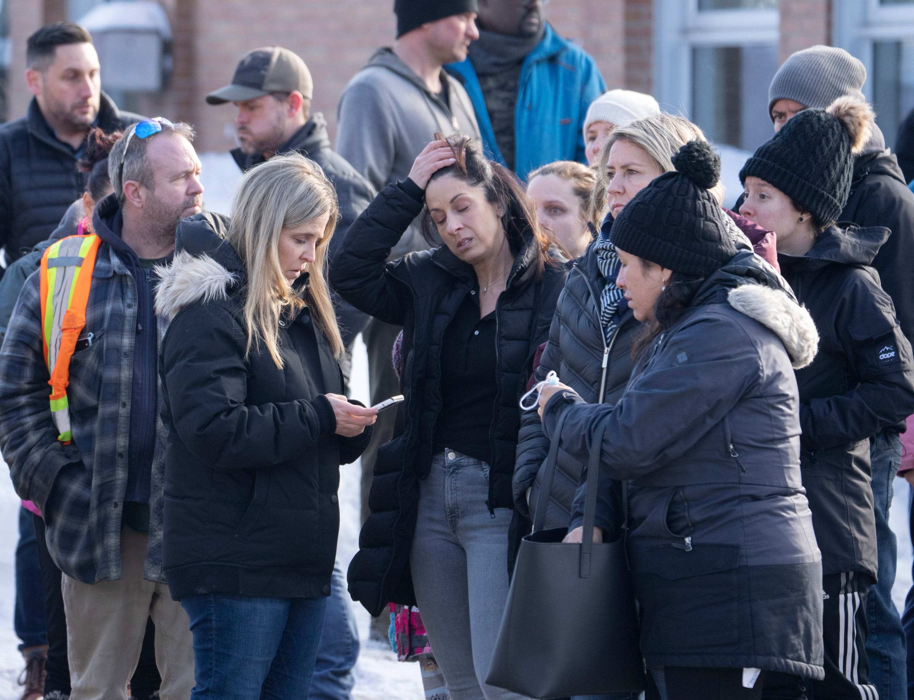 Families wait for news after a bus crashed into a nursery in Laval, Quebec.