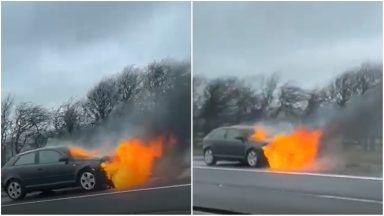 Drivers face tailbacks after car fire and oil spillage on M8 near Newbridge.