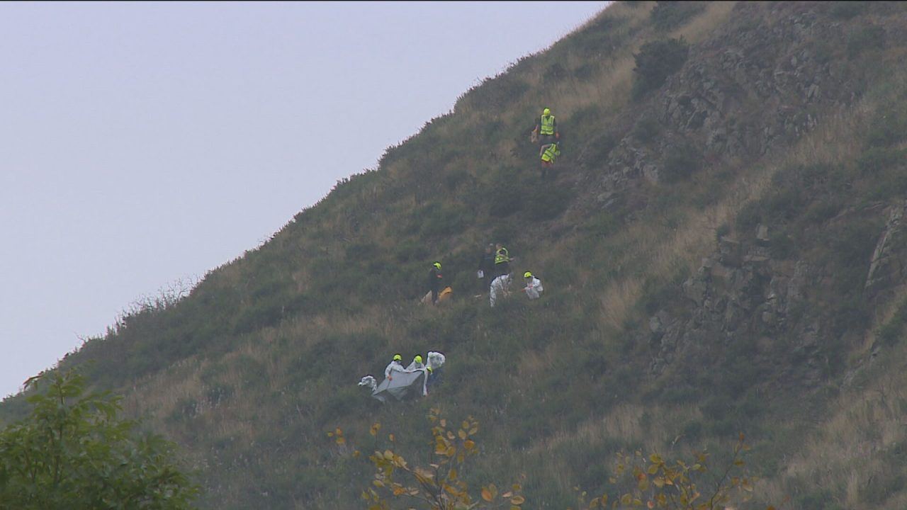 Police forensics teams are seen on Arthur's Seat