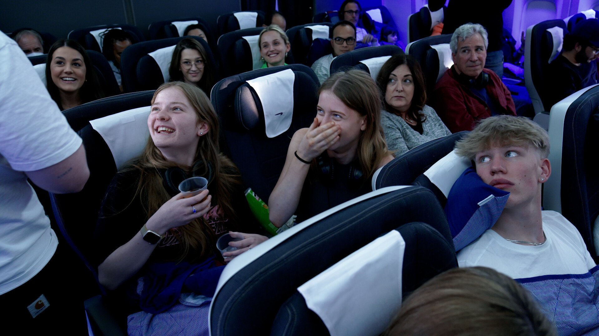 Four unsuspecting 'superfans' were specially invited onto the flight for the event. 