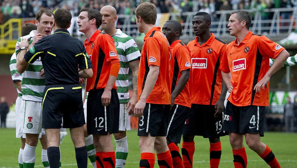 Celtic and Dundee United players surround referee Dougie McDonald after a penalty awarded to Celtic is overturned.