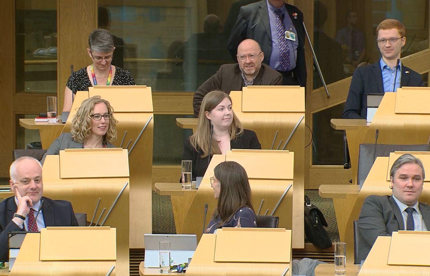 Scottish Green MSPs watch as SNP MSP Fergus Ewing criticises their plans for a transition from fossil fuels.