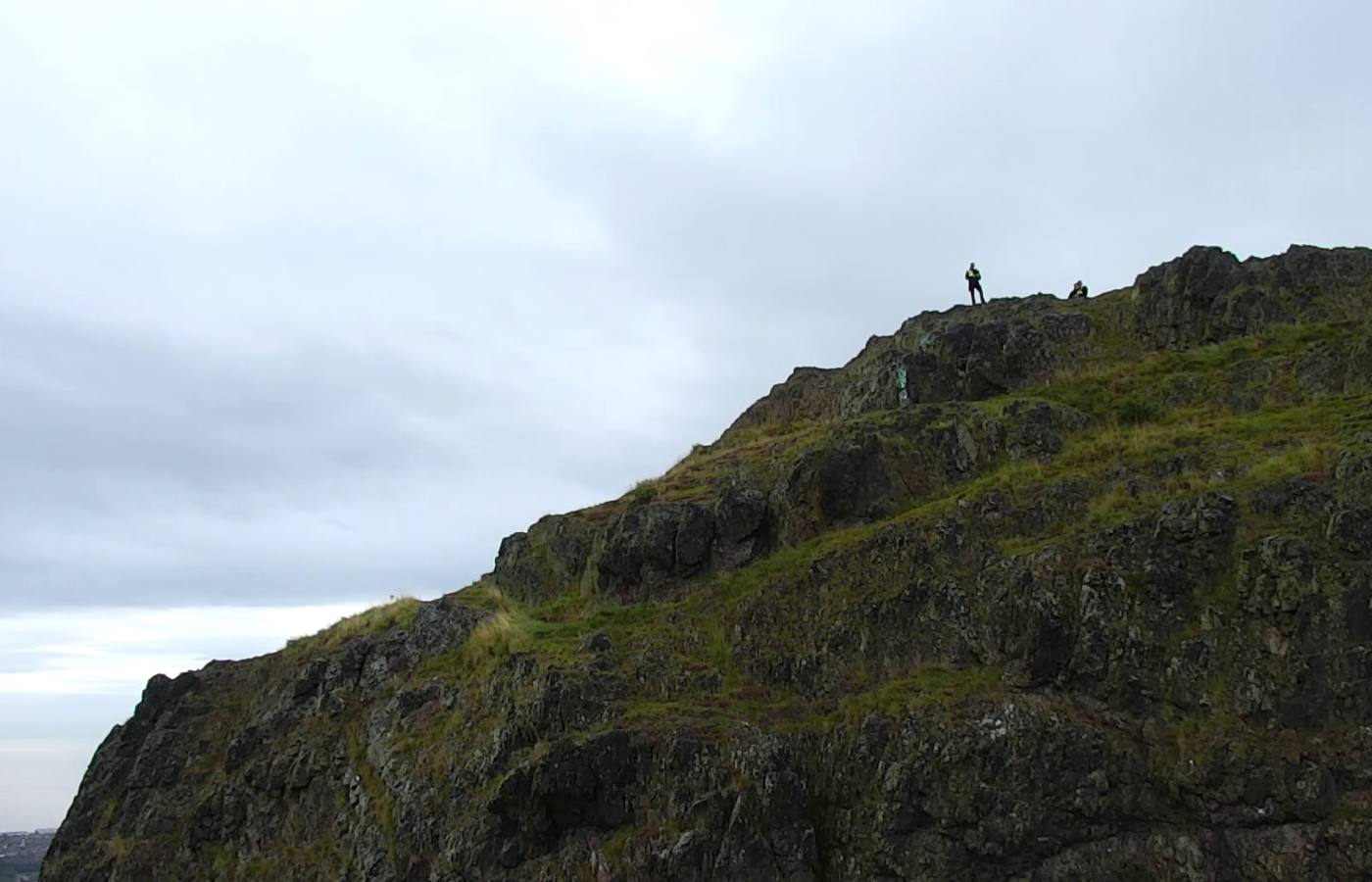 Police survey the fall area at Arthur's Seat.