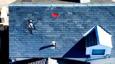 Roofer brings world-famous Banksy design to building top in Inverness