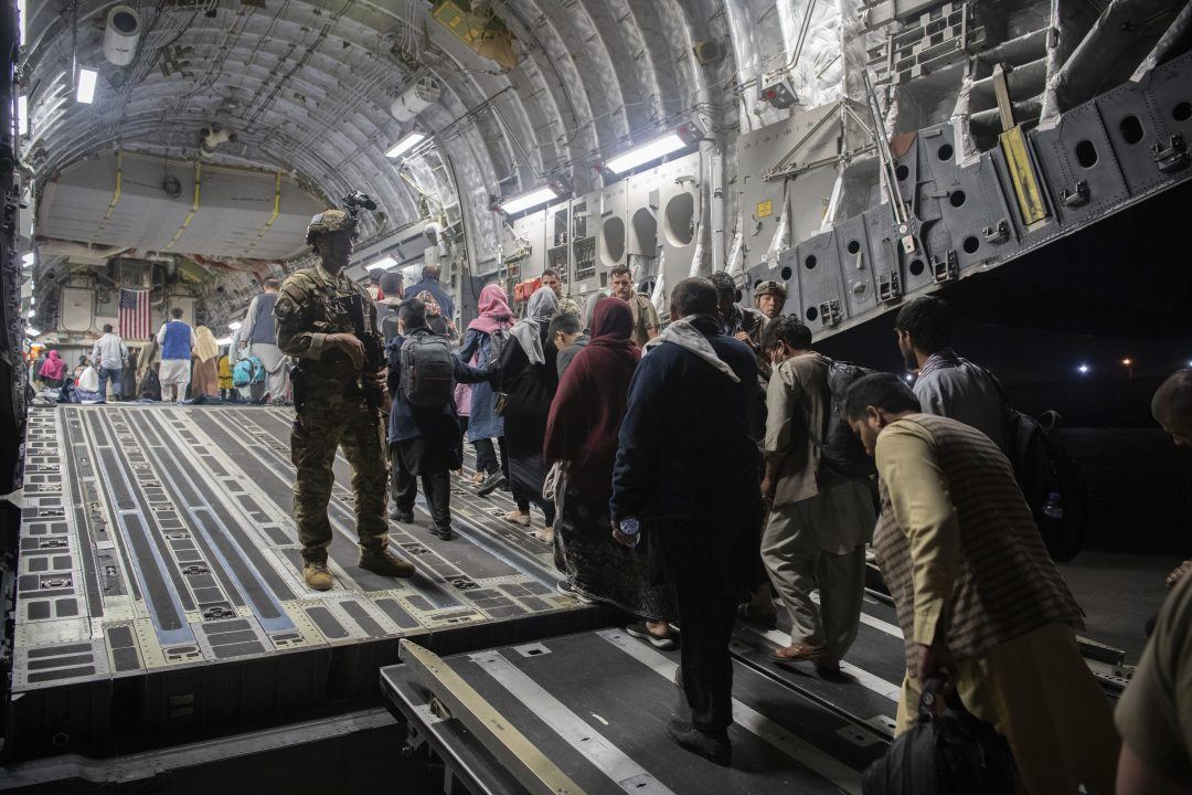 Afghan passengers board a US Air Force C-17 Globemaster III during the Afghanistan evacuation at Hamid Karzai International Airport in Kabul, Afghanistan (MSgt. Donald R Allen/US Air Force via AP)