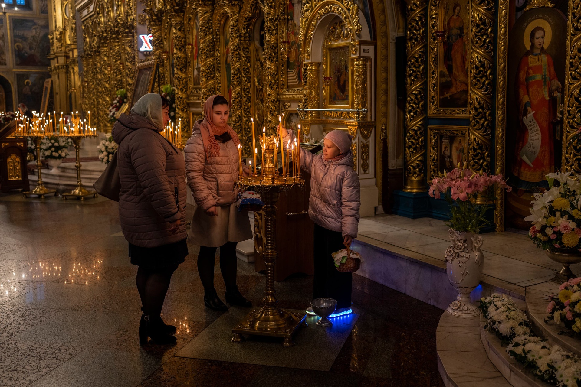 Orthodox Christian worshippers light candles during an Easter Sunday service in Kyiv (Bernat Armangue/AP/PA)