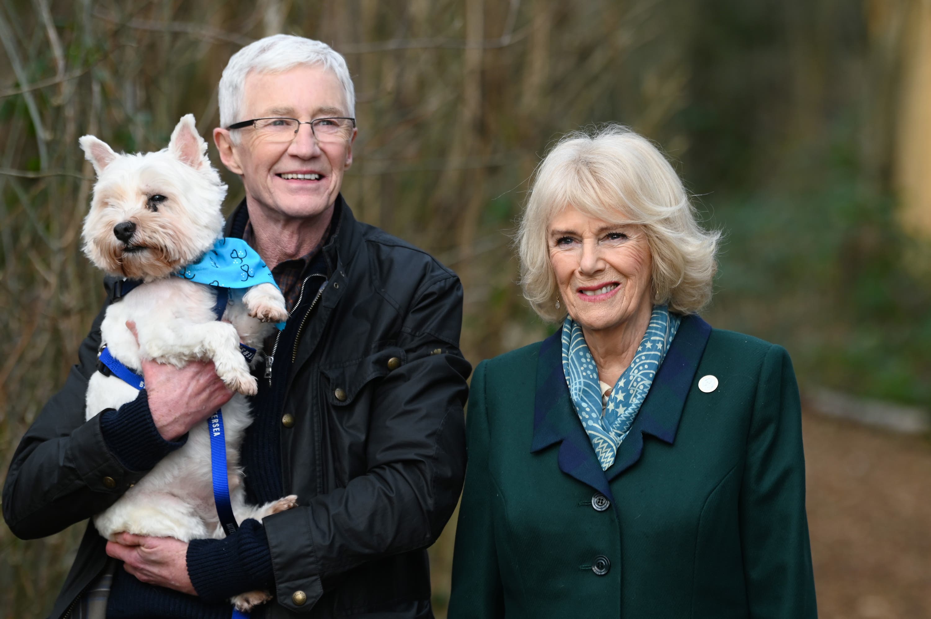 The Queen Consort on a walk with Battersea ambassador Paul O’Grady and a rescue dog during her visit to the centre.