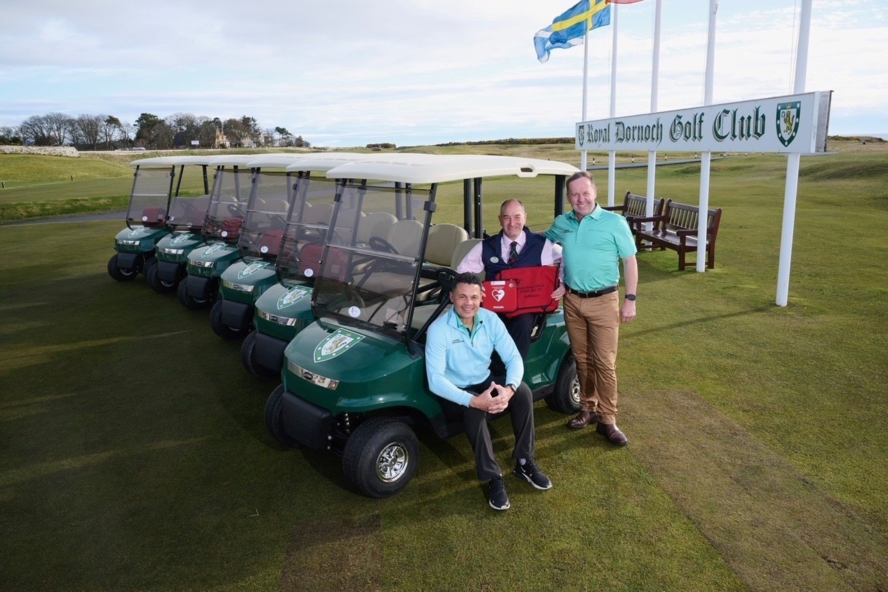 Royal Dornoch general manager Neil Hampton (centre) welcomes the installation of ground-breaking buggy defibrillators with CPR campaigners, former England footballer John Salako (left) and David Sullivan (right).