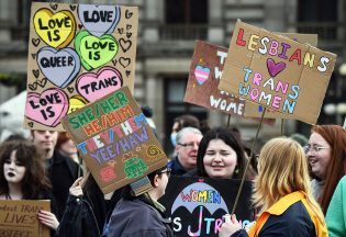 Trans Rights activists hold placards while taking part in the "Furies against Fascism" counter protest to the "Let Women Speak" rally in Glasgow, on February 5, 2023