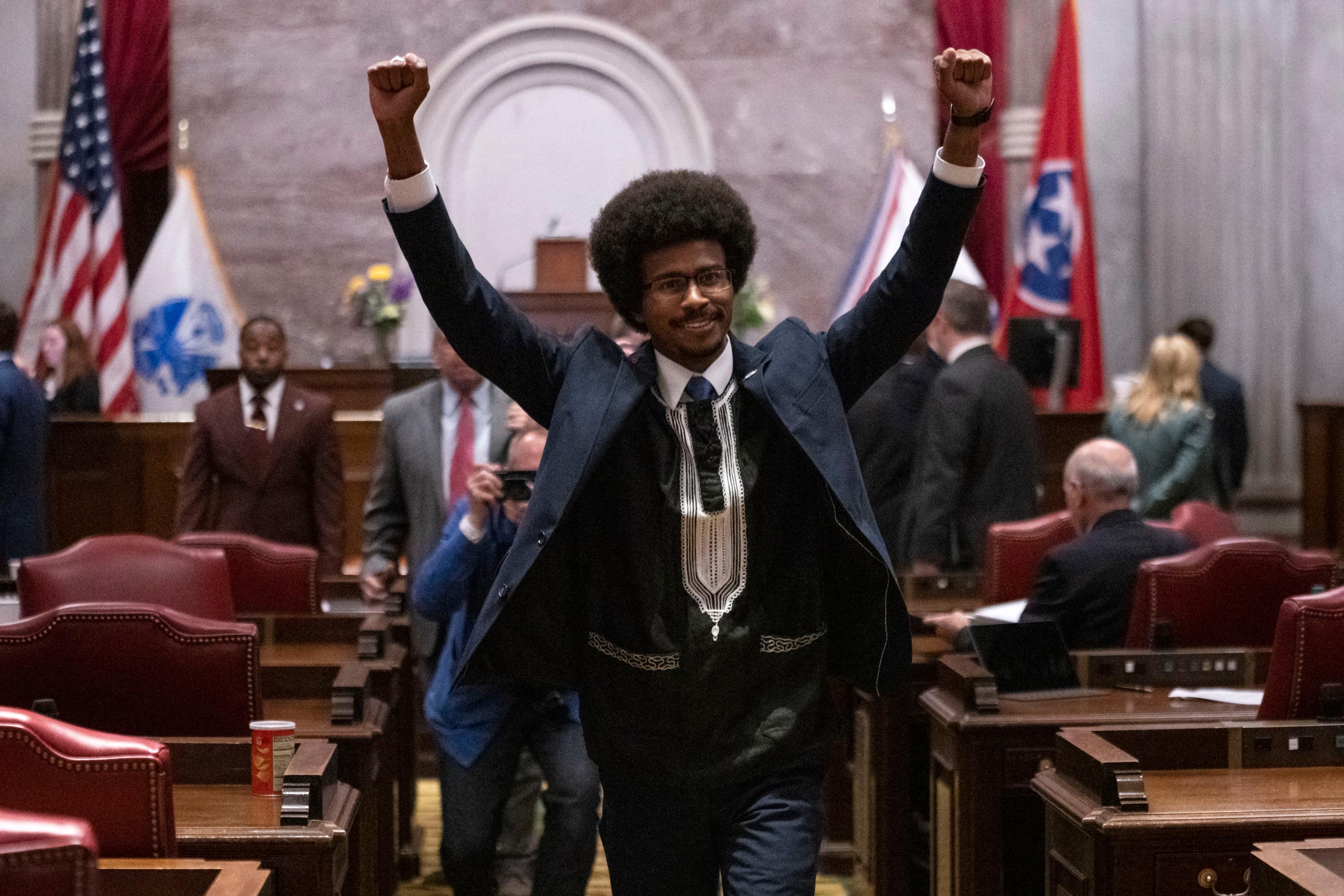 Justin Pearson raises his fists as he leaves the House chamber after he was expelled from the legislature on Thursday.