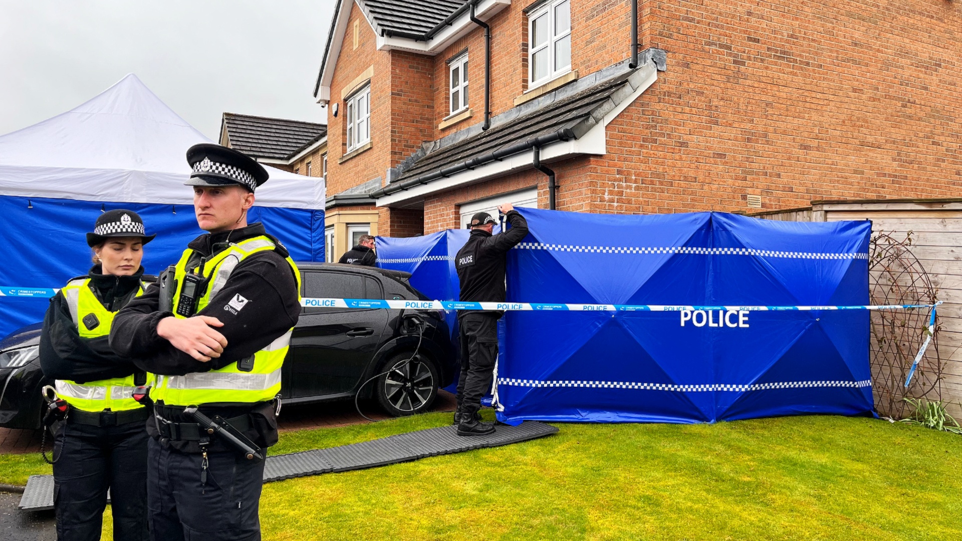 A forensic tent was erected outside the former first minister's home in Uddingston.
