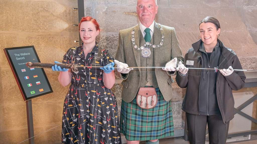 Collections manager at the Smith Museum Nicola Wilson, Stirling provost Douglas Dodds and marketing officer Katie McKay held the sword before placing its back in its case on Thursday. 