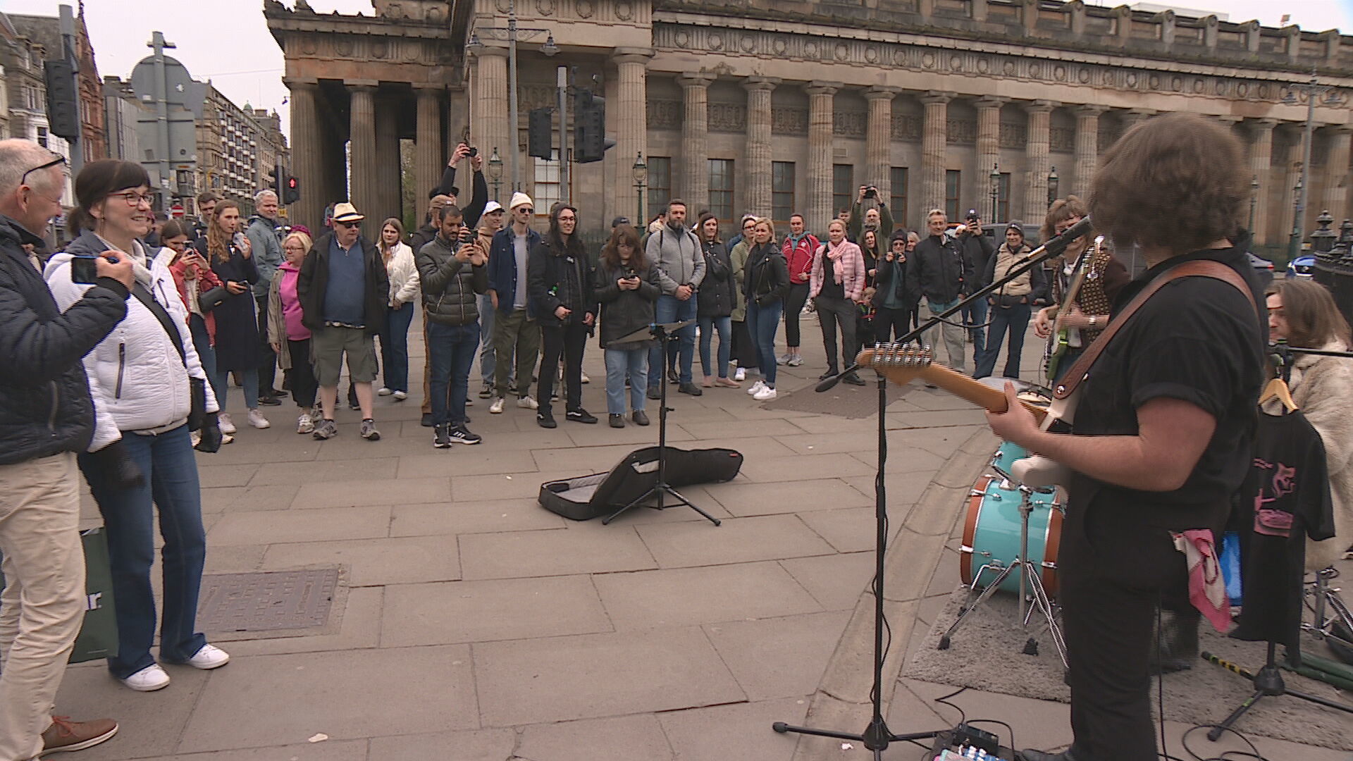 High Fade Music busking to an audience on Princes Street in Edinburgh. 