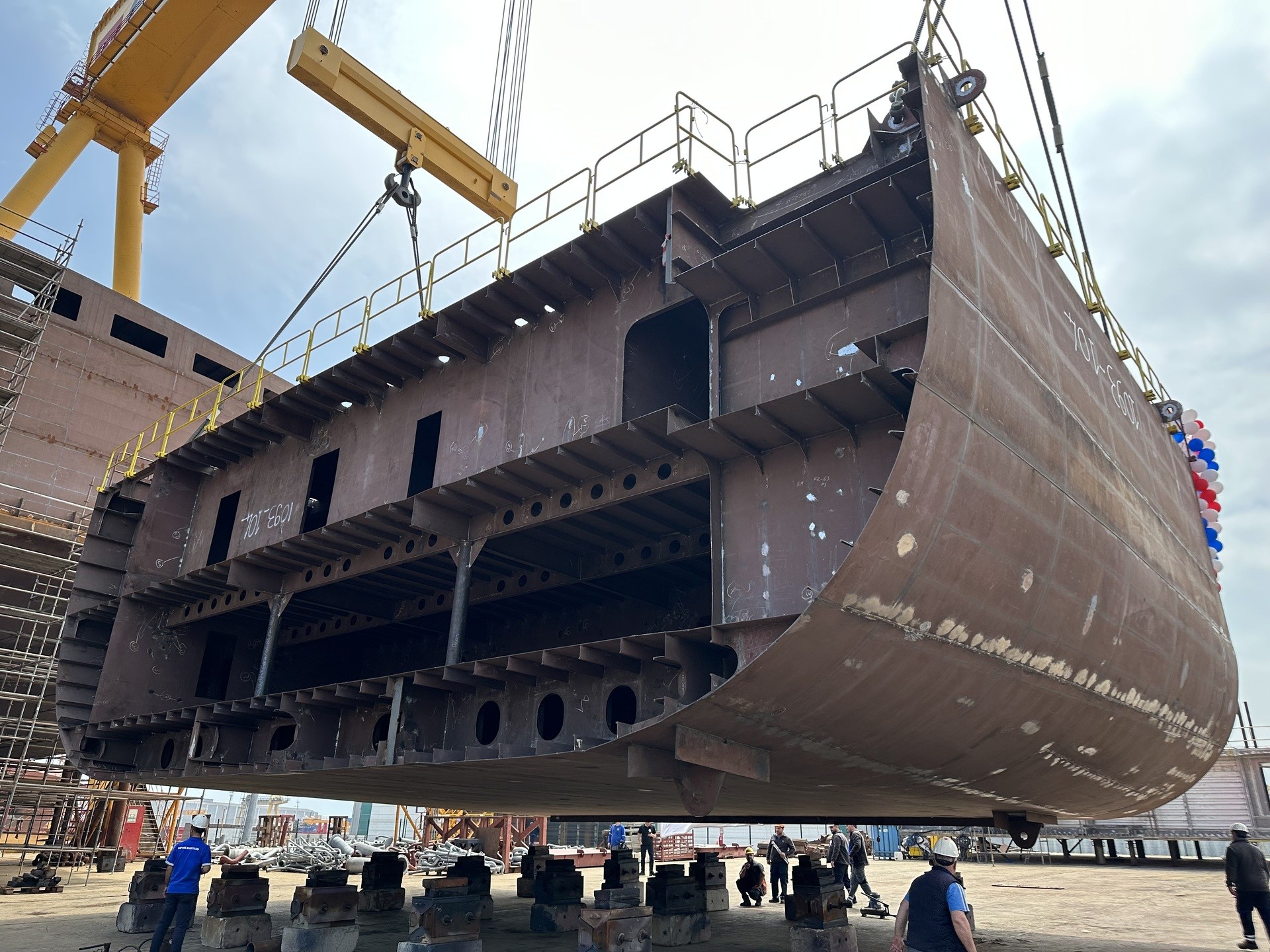 Keel of Loch Indaal being lifted to be put in place above Isle of Islay on the slipway,