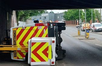 Van overturns after colliding with bridge in Paisley