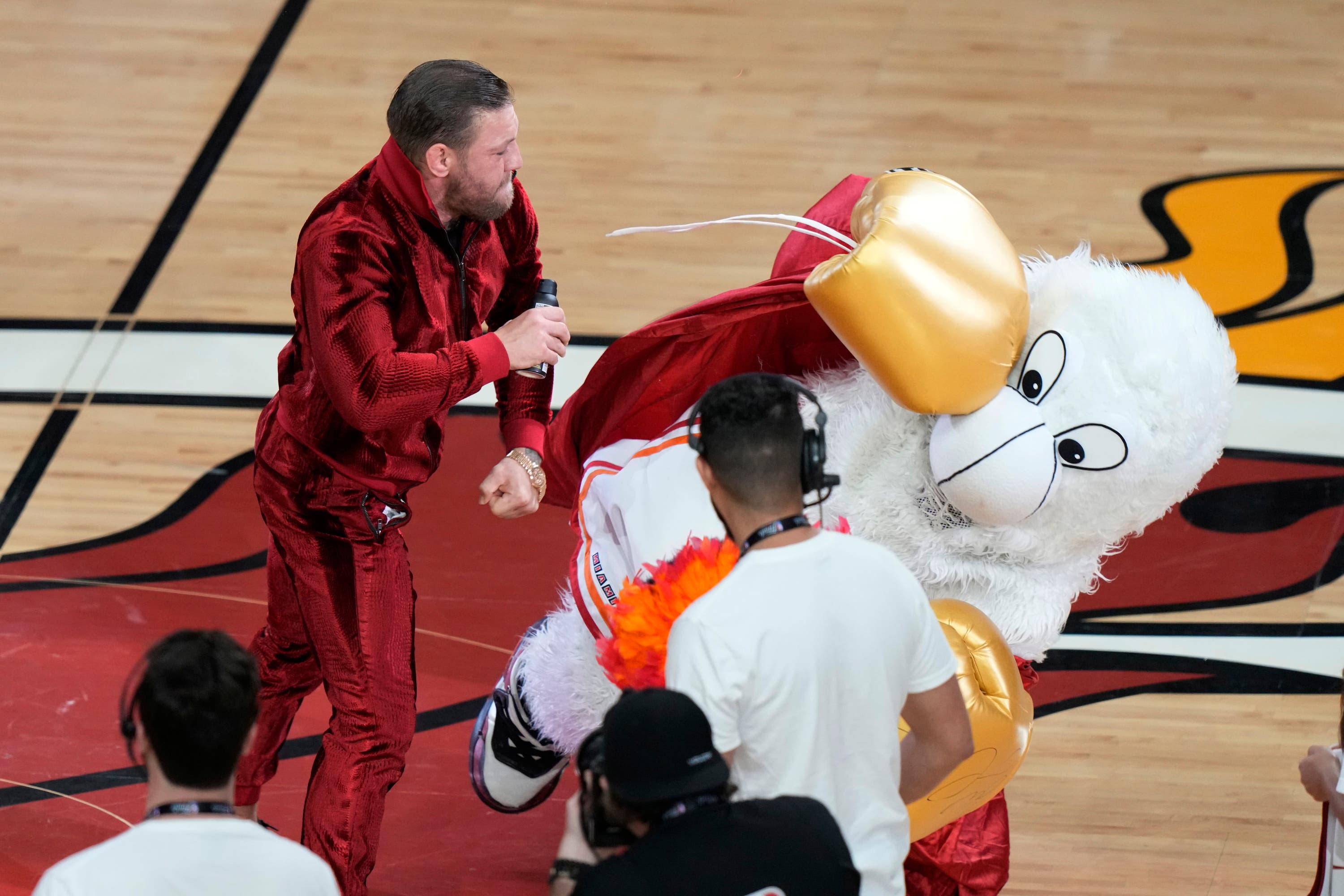Former MMA fighter Conor McGregor punches Burnie, the Miami Heat mascot, during a break in Game 4 of the NBA Finals against the Denver Nuggets.