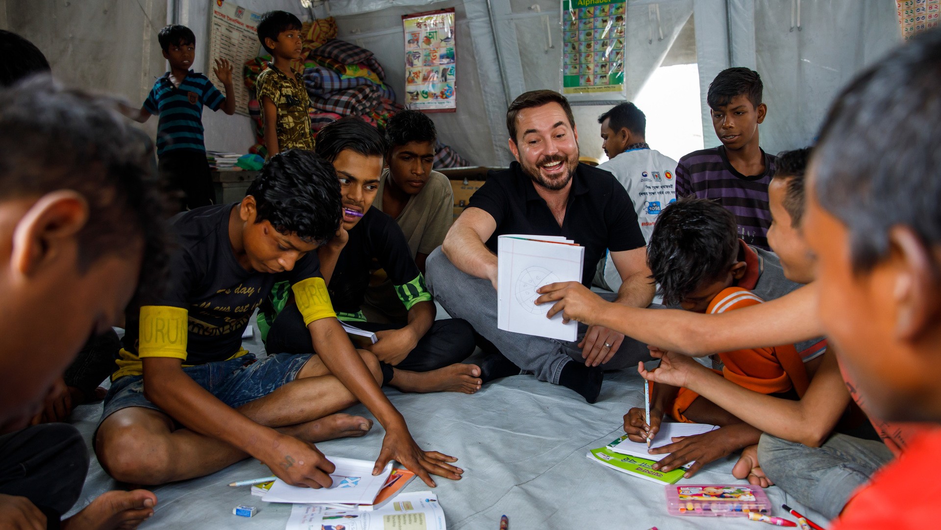 Actor Martin Compston plays games with Nirob, Hridoy and other children at Kamalapur Street Hub in Dhaka, Bangladesh. 