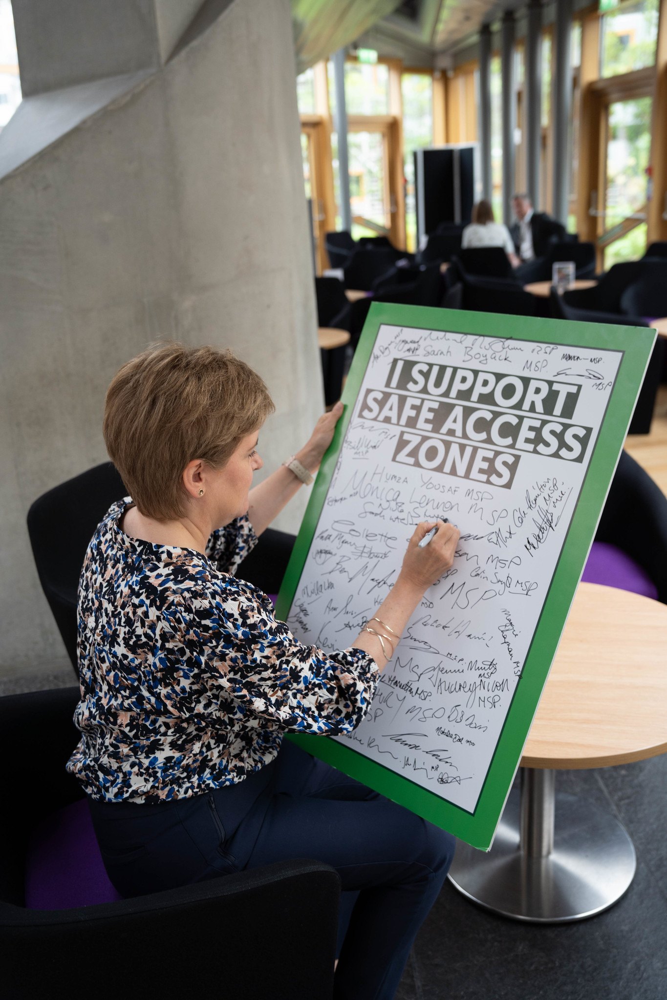 Nicola Sturgeon signs Gillian Mackay's buffer zones bill proposal.