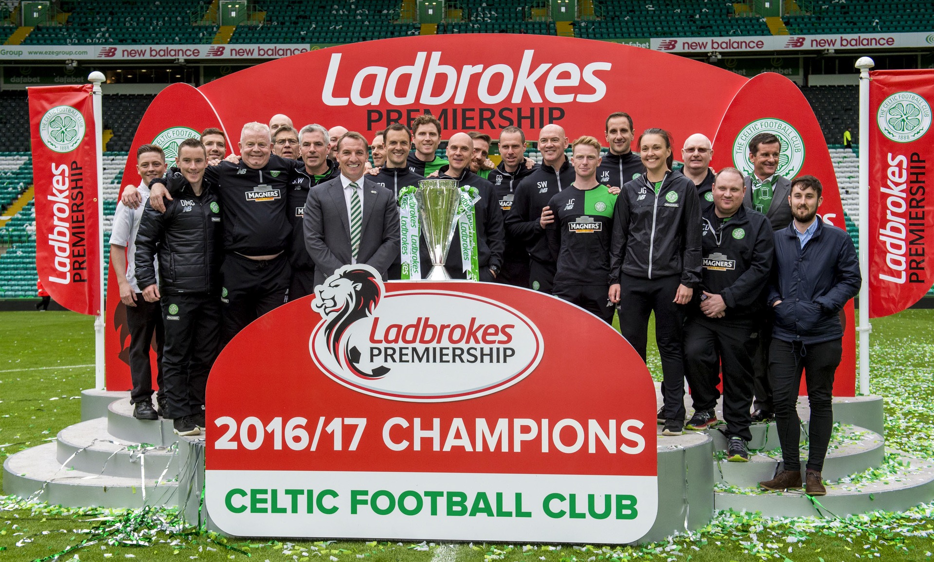Brendan Rodgers (centre left) with his backroom staff and the Ladbrokes Premiership trophy. (Photo by SNS Group)