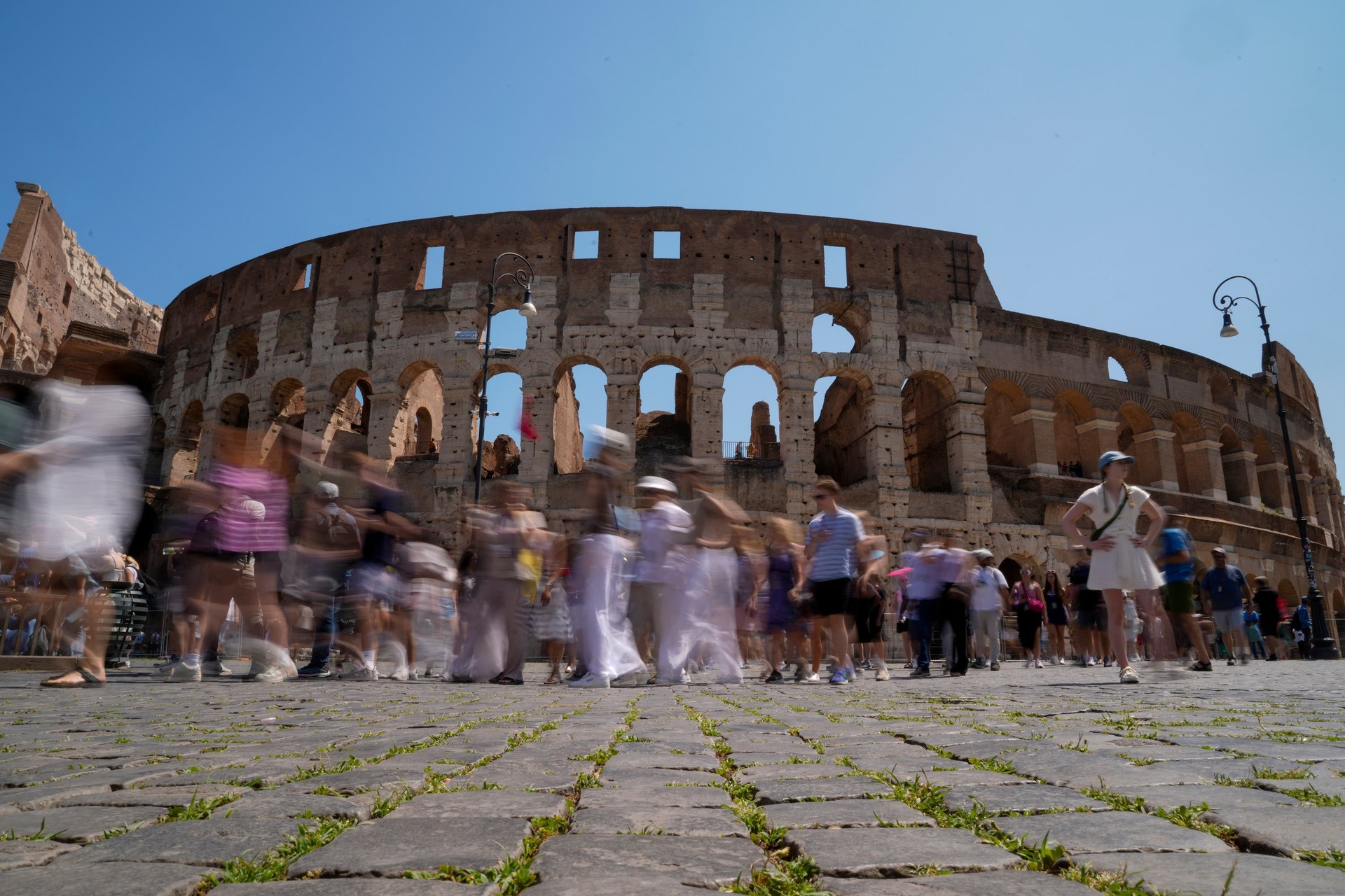 Visitors walk past the Colosseum in Rome where a visitor was spotted carving their name.