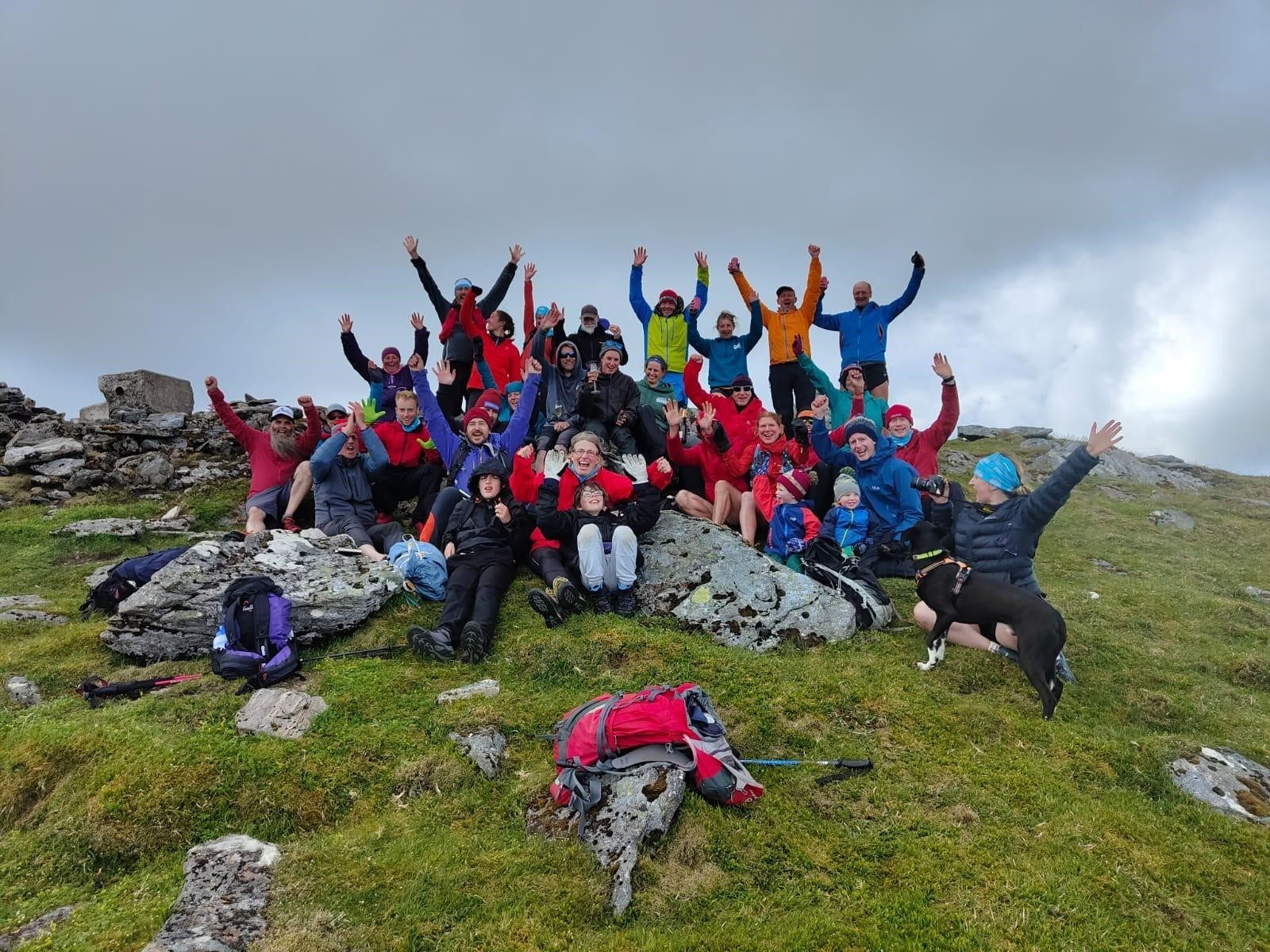 he endurance athlete celebrated with supporters at the end of the trek – known as Jamie’s Munro Challenge. (Andy Stark/Stark Images/PA)