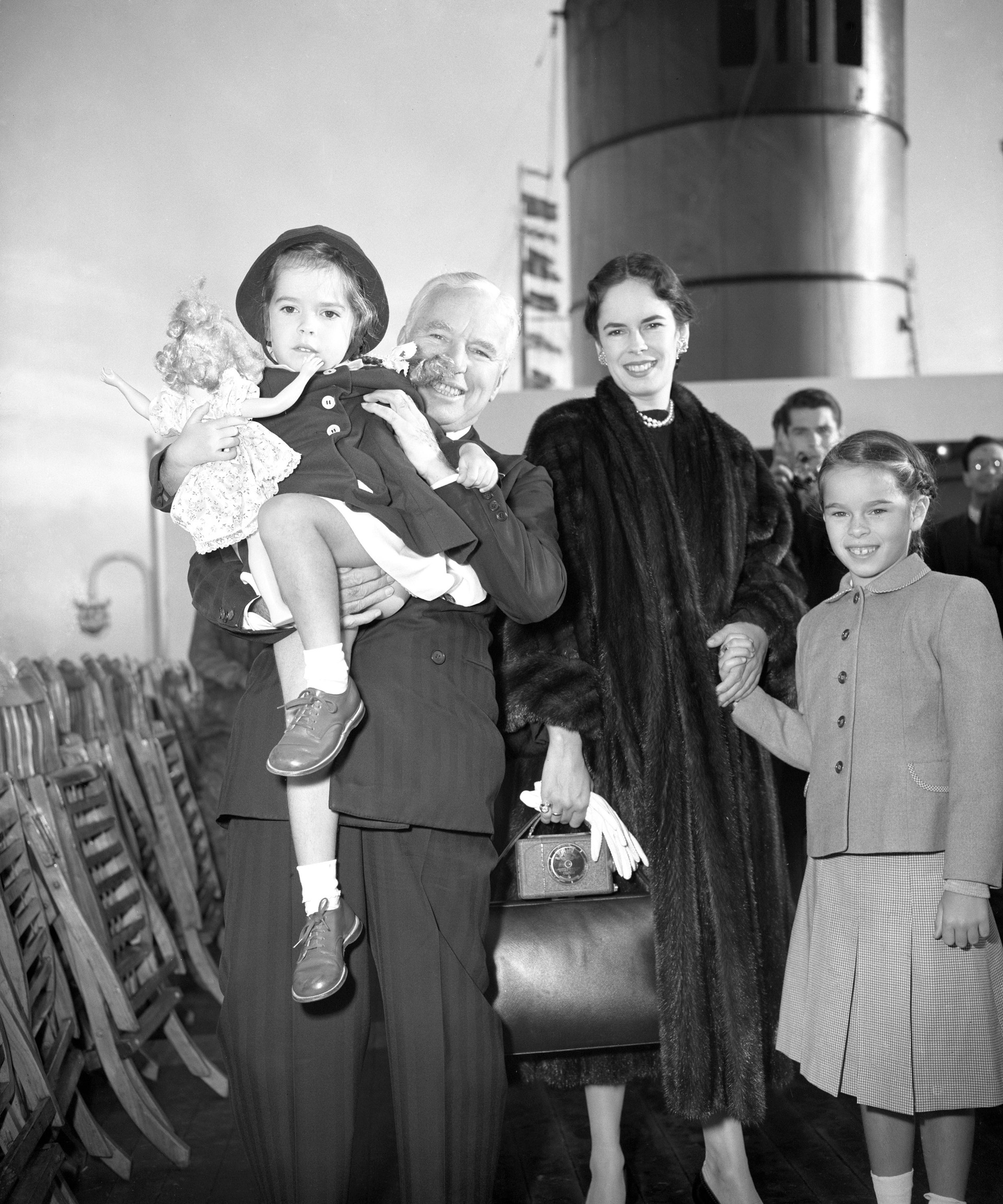 Charlie Chaplin, arriving in Southampton with his wife and two of their daughters, Geraldine, 8, and Josephine, 3 (PA)
