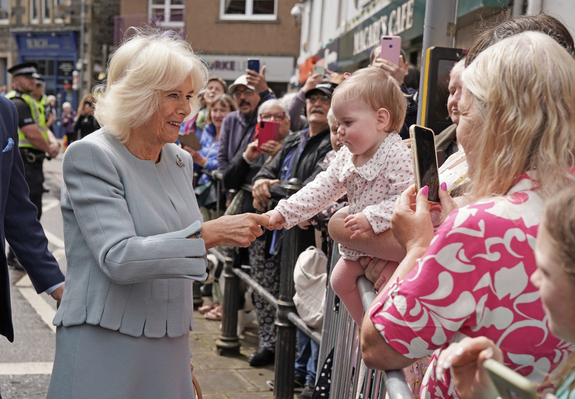 Camilla was greeted by a young well-wisher outside the visitor centre (Andrew Milligan/PA)
