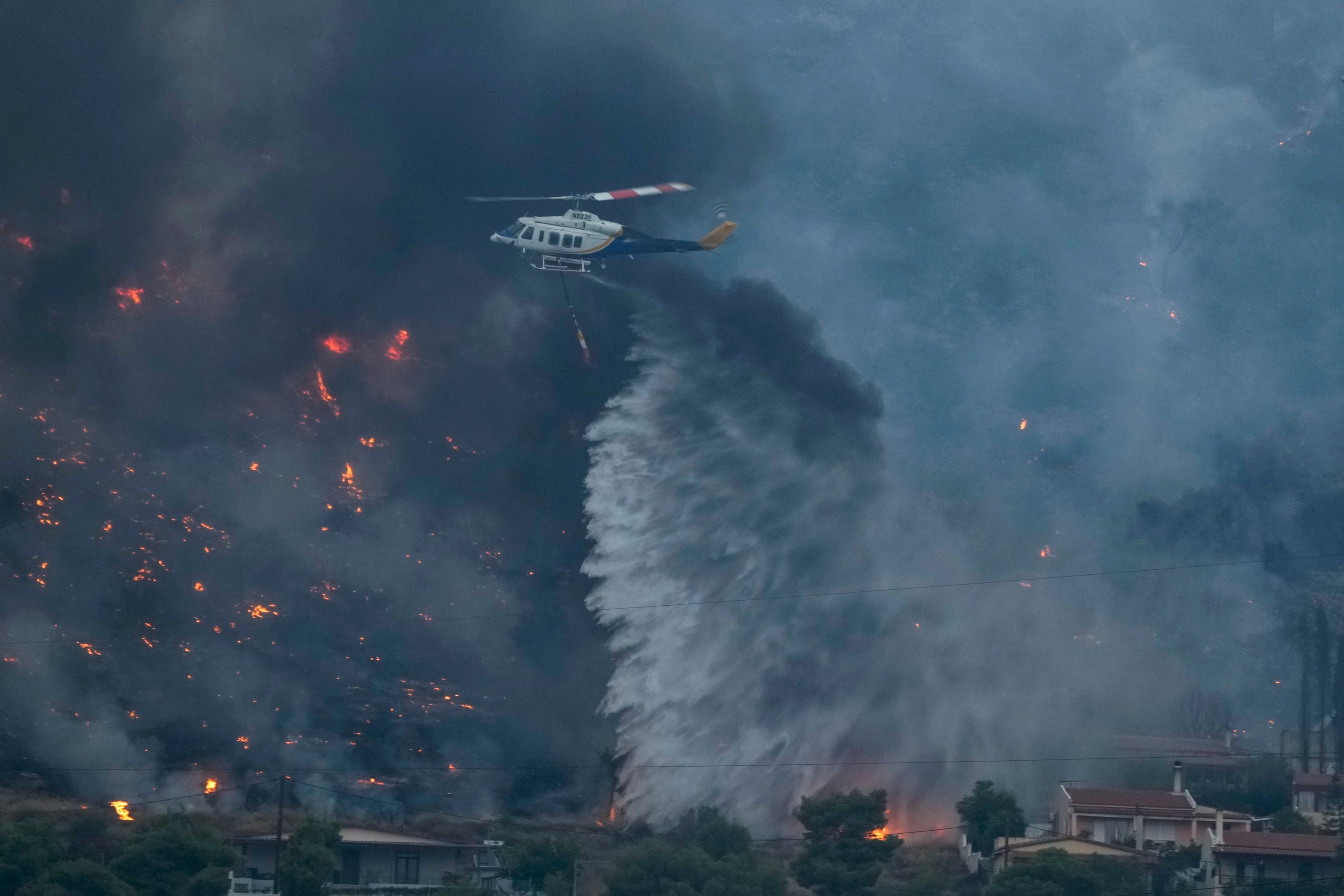 Greek emergency services have been battling wildfires (Petros Giannakouris/AP)