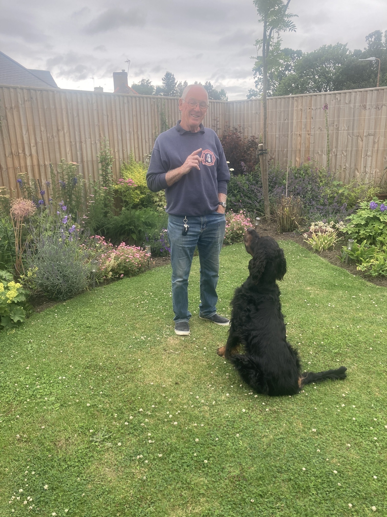 Ronald Anderson and the family dog Barclay enjoy their garden.