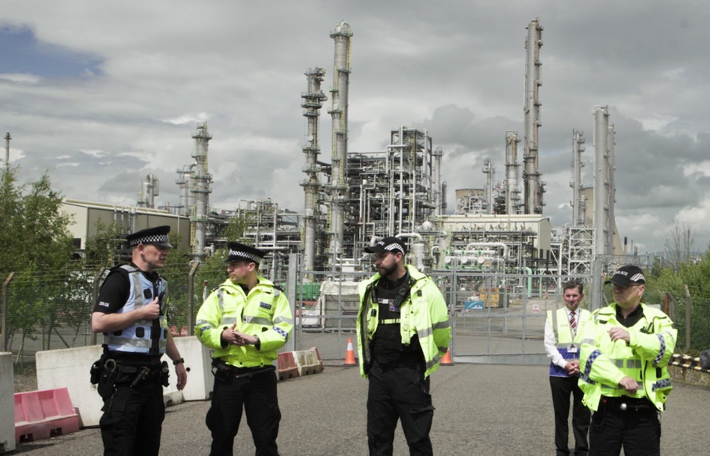 Police stood at the entrance of Ineos' Grangemouth oil refinery as protestors approached