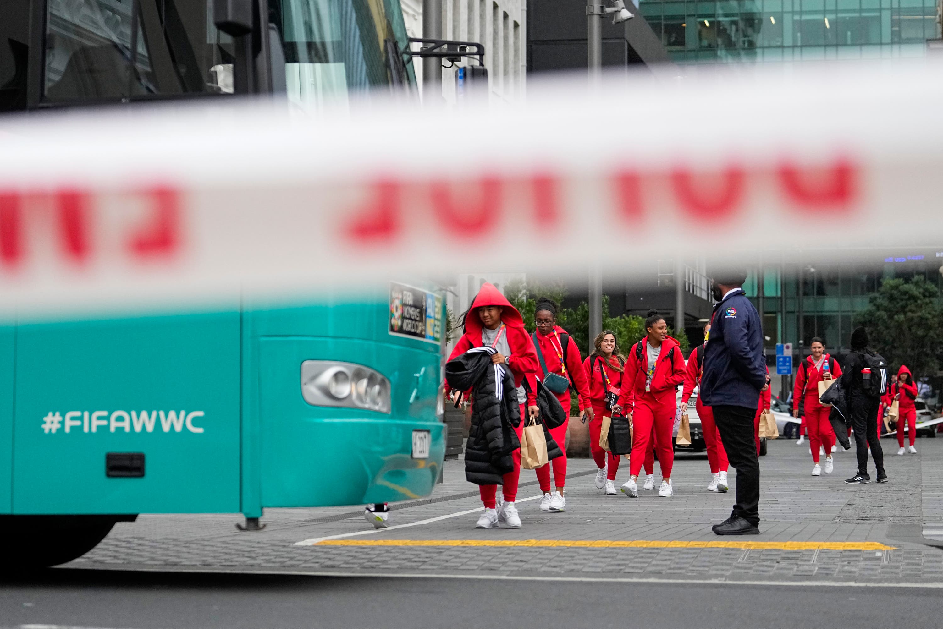 Members of the Philippine Women’s World Cup team walk to their team bus following the shooting near their hotel.