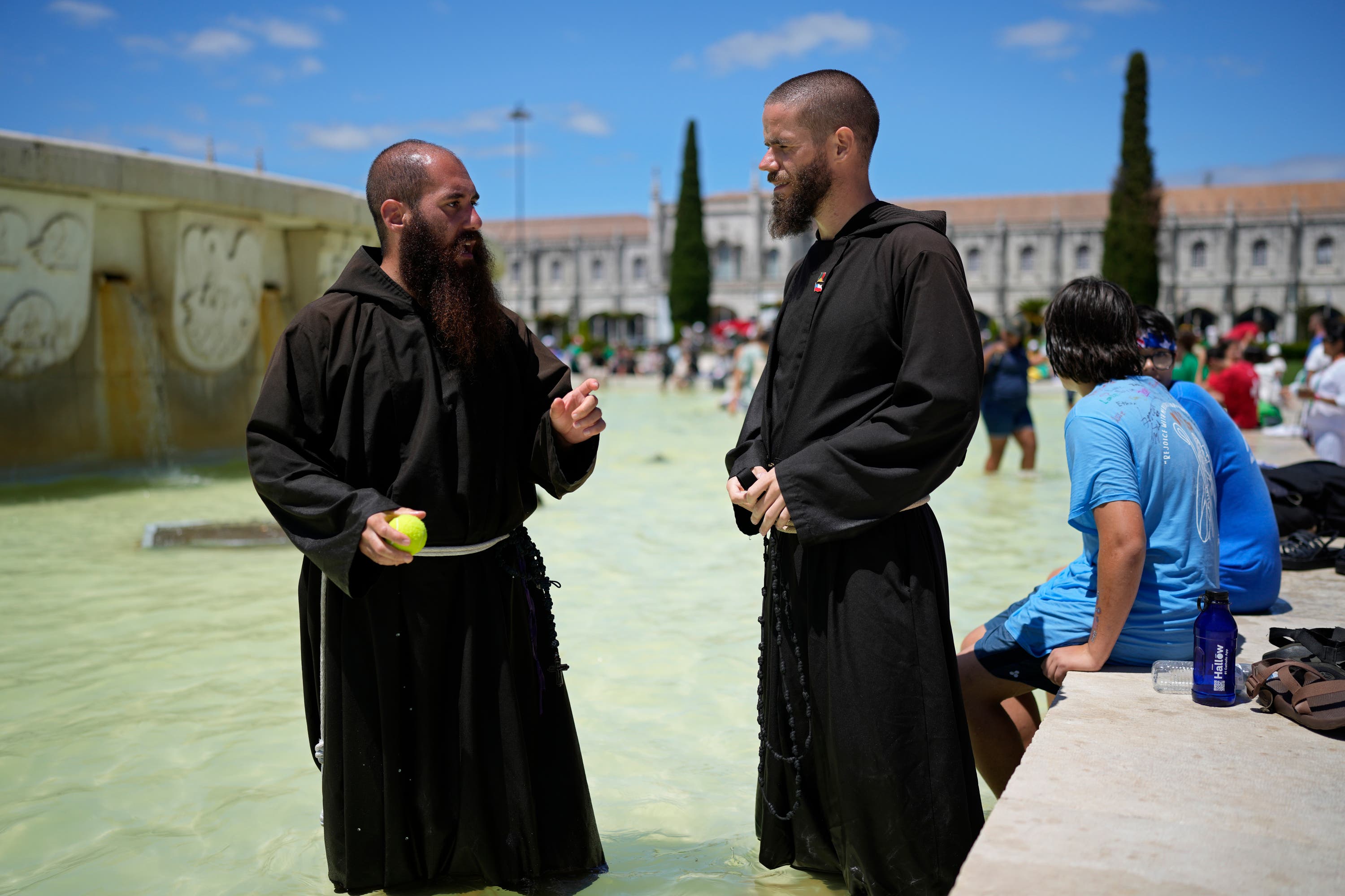 Two priests in front of the Jeronimos Monastery where Pope Francis visited.