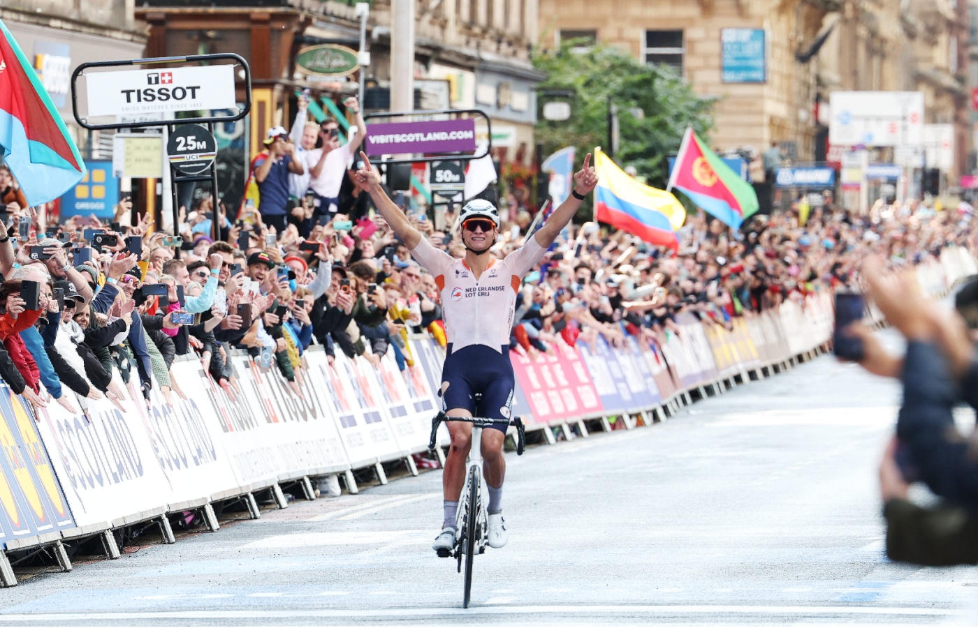 Mathieu Van der Poel of the Netherlands celebrates winning the UCI Cycling Championship men's elite road race in Glasgow.