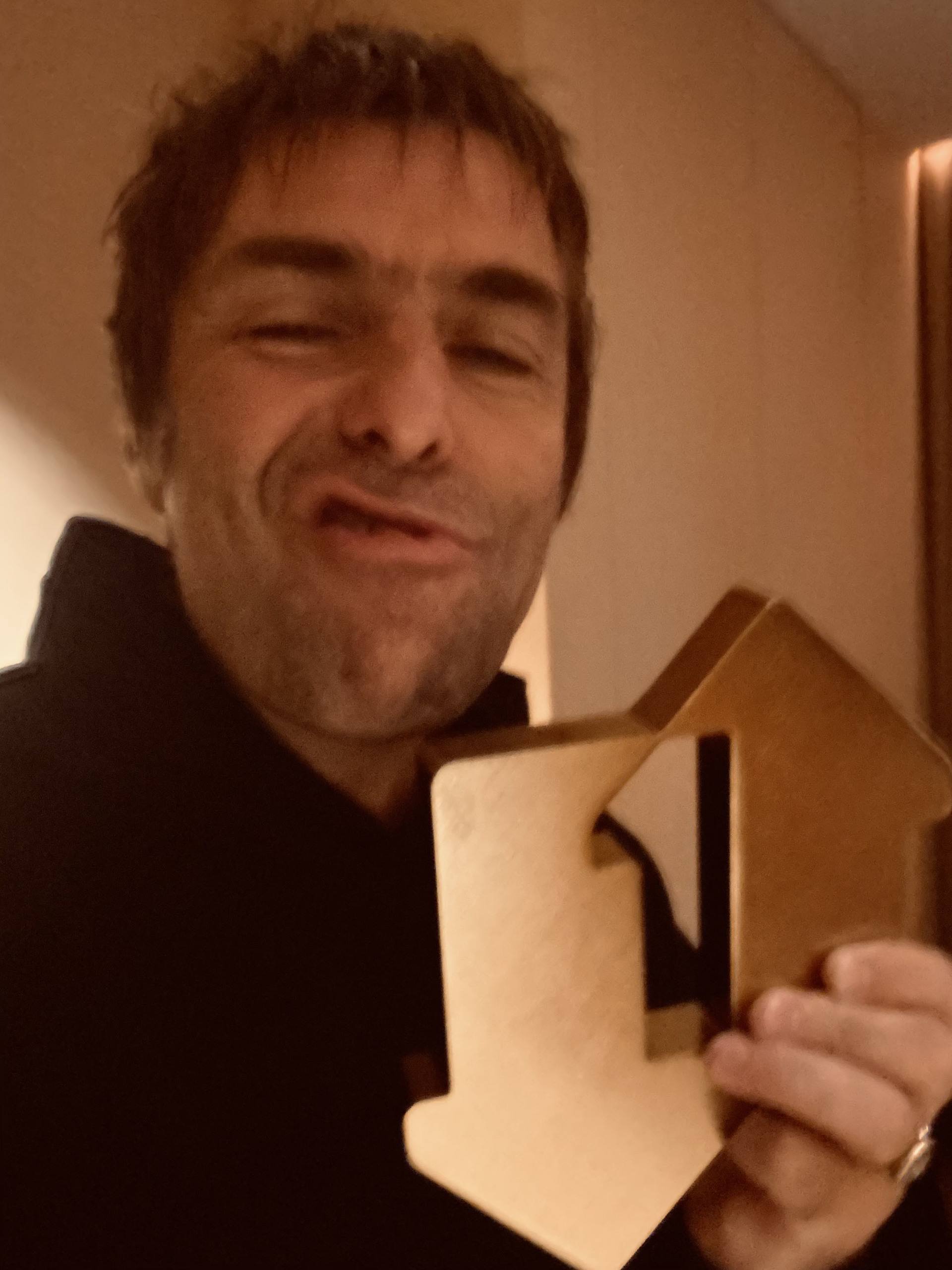 Liam Gallagher with his official number one album award for Knebworth 22.