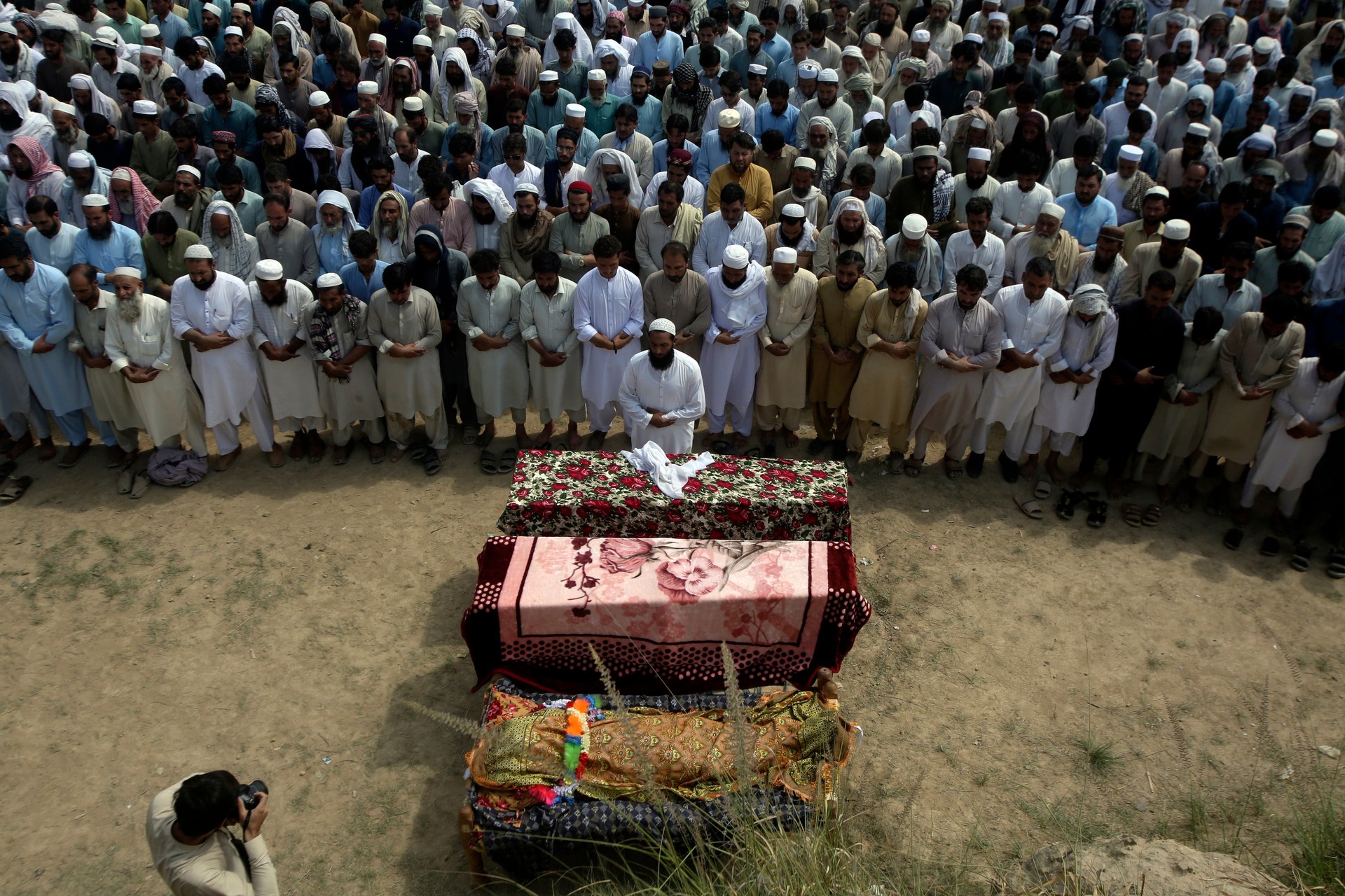 Relatives and mourners attend the funeral of victims who were killed in Sunday’s suicide bomber attack.