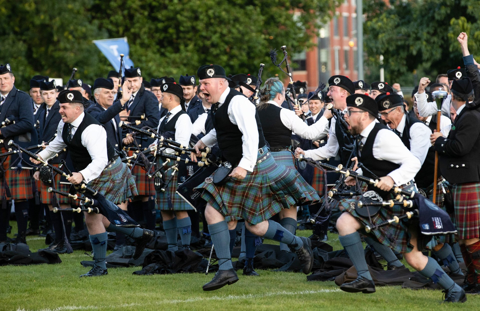 The Boghall and Bathgate Caledonia Pipe Band celebrates winning the World Pipe Band Championships.