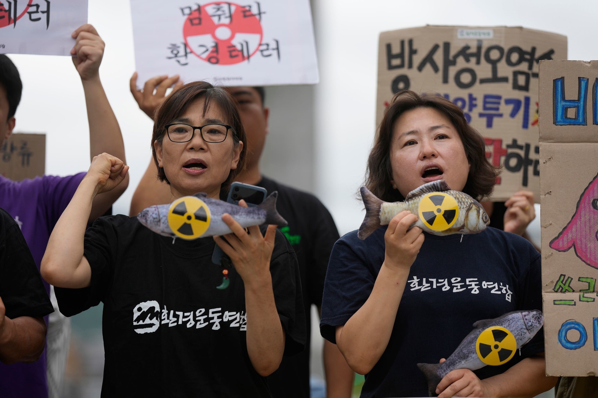 Members of an environmental group shout slogans during a rally to demand the stop of the Japanese government’s decision in Seoul, South Korea.